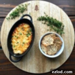 Easy Honey Roasted Feta Dip in a small cast iron pan with a serving spatula.