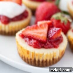 Close up of a mini cheesecake topped with strawberries.