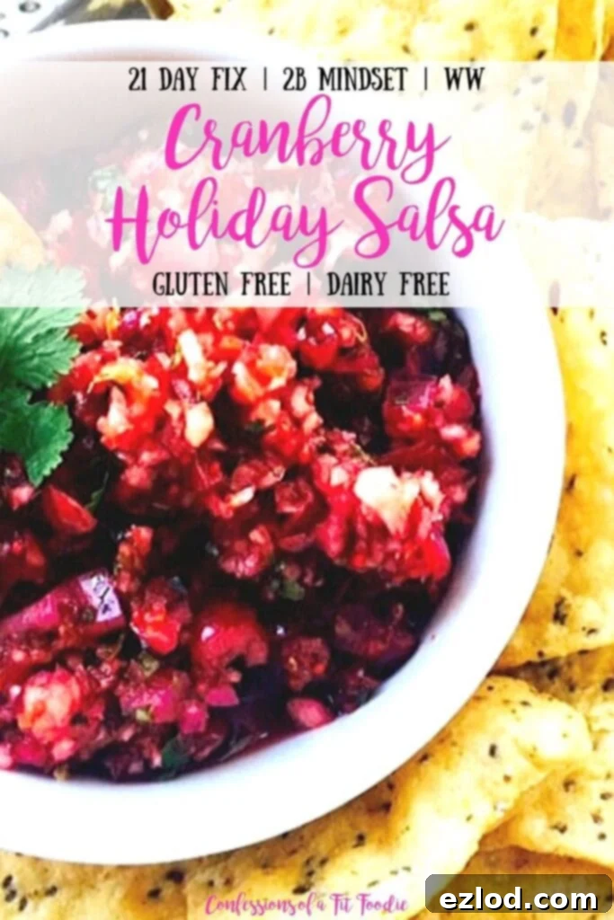 Close up photo of Cranberry Holiday Salsa in a white bowl with tortilla chips and the text overlay- 21 Day Fix | 2B Mindset | WW | Cranberry Holiday Salsa | Gluten Free | Dairy Free | Confessions of a Fit Foodie
