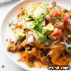Plate of crock pot chicken enchilada casserole made in the crock pot.