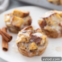 Three French toast cups are on a white plate, ready to be enjoyed as a healthy breakfast.
