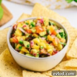 Fresh peach salsa with cilantro, peppers, and avocado.