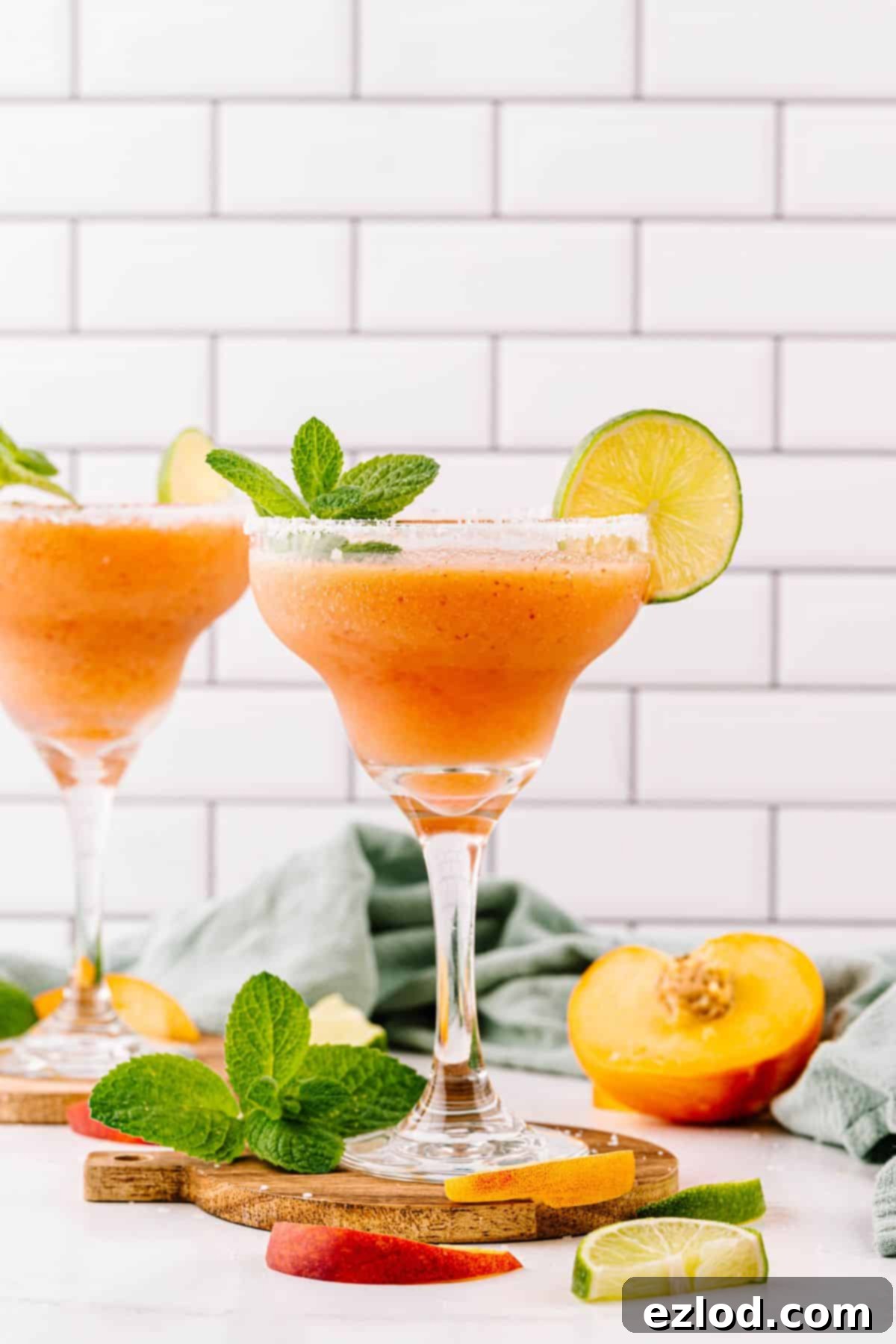 Two glasses of homemade peach margaritas.