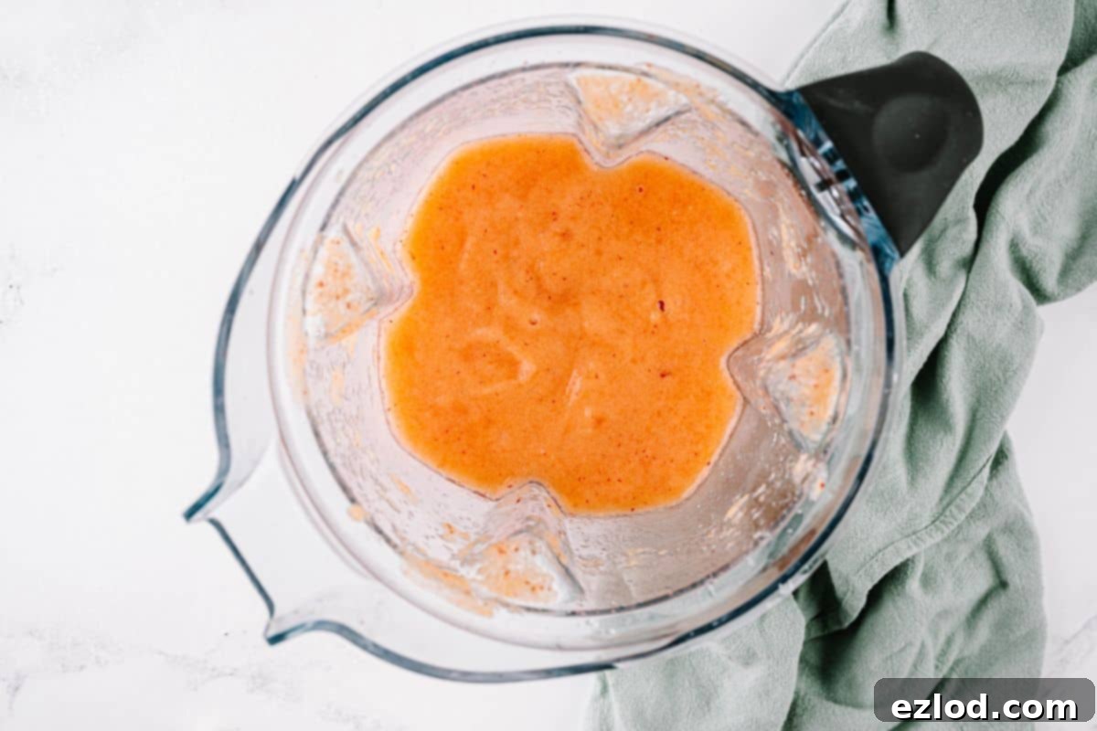 A blender with homemade peach margarita.