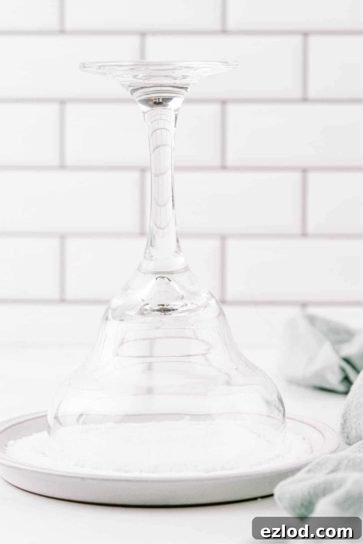 A margarita glass in a dish of salt.