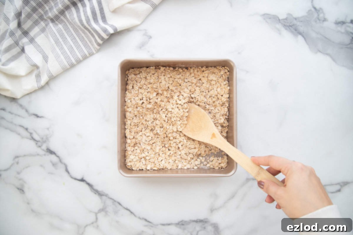 Dry ingredients in a square baking dish for baked oats.