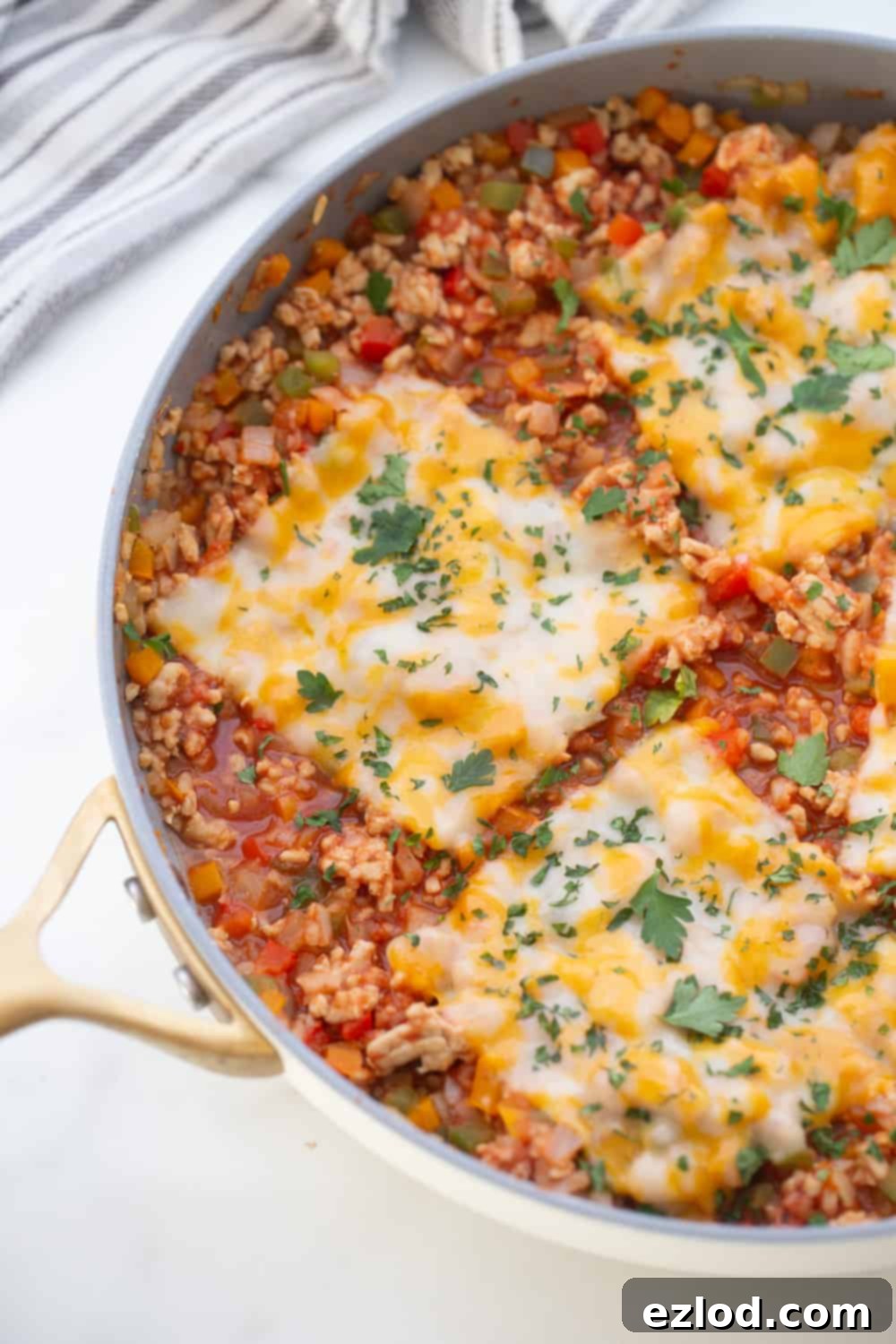 Stuffed Pepper skillet topped with three pieces of Monterey Jack Cheese.