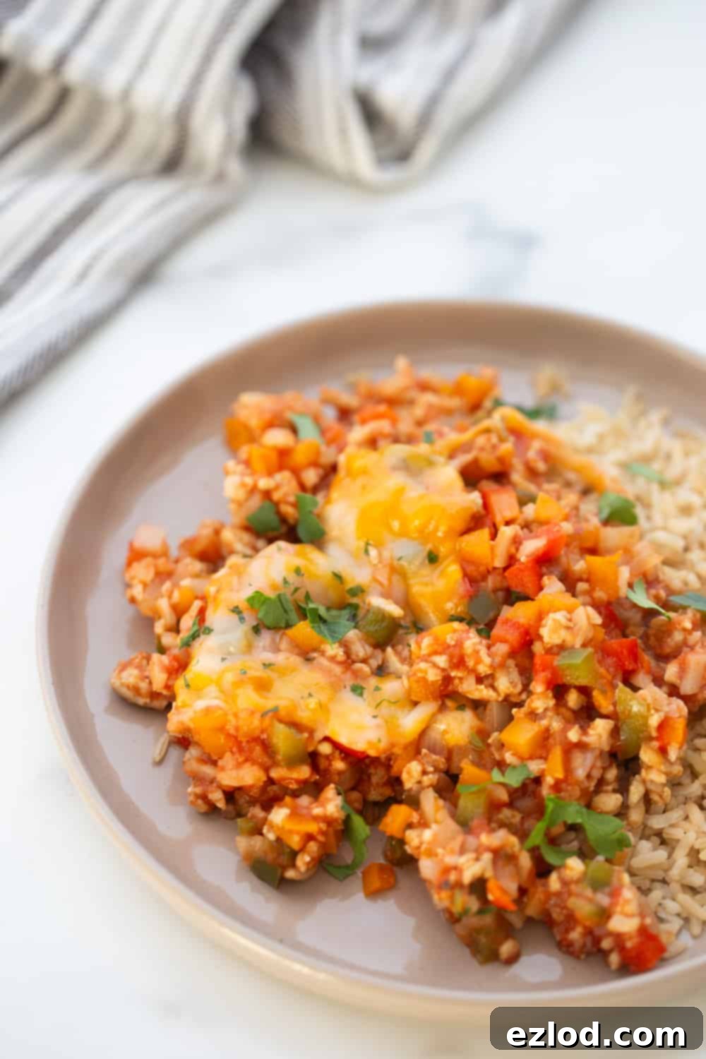 This low carb stuffed pepper skillet recipe has all the flavors of stuffed peppers without the fuss!  It's high protein, full of veggies, and made entirely in one skillet and the whole thing is ready in under 30 minutes.  