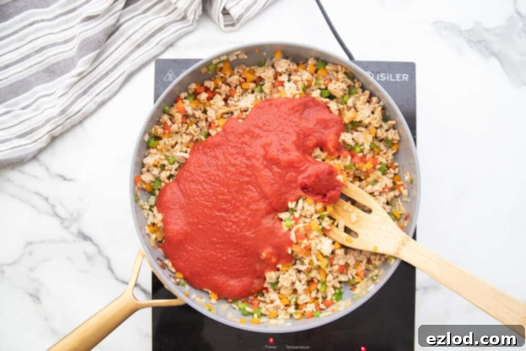 Stuffed Pepper skillet with tomato sauce on top.