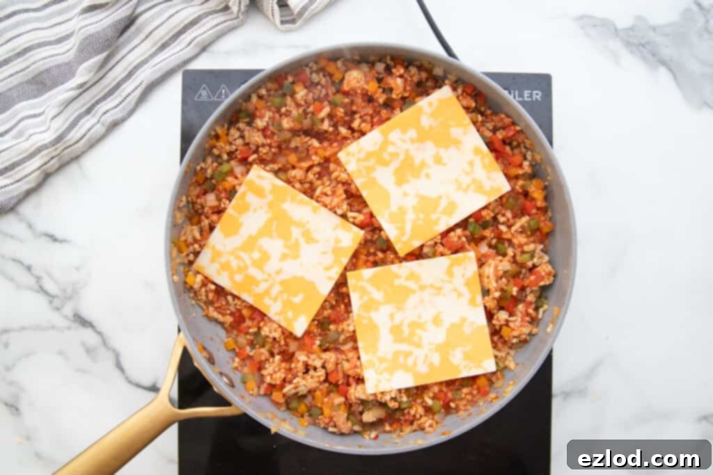 Stuffed Pepper skillet topped with three pieces of Monterey Jack Cheese.