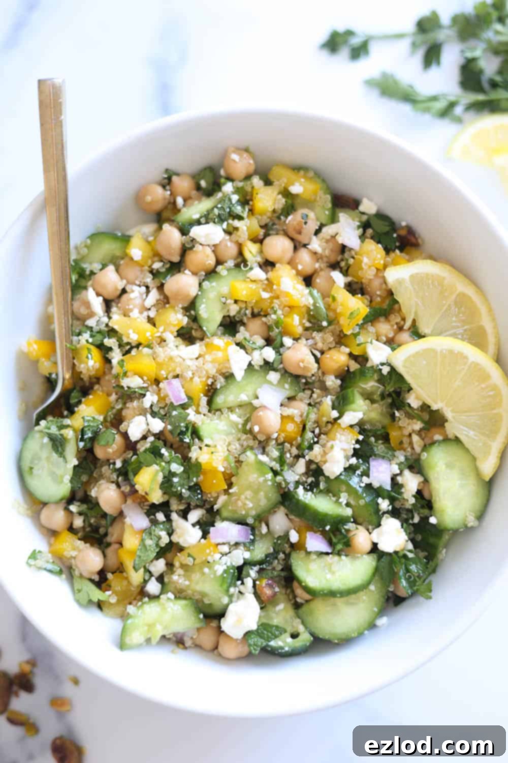 Bowl of the viral Jennifer Aniston Salad with chickpeas, quinoa, fresh veggies, and a lemon vinaigrette, showcasing its fresh, colorful ingredients.