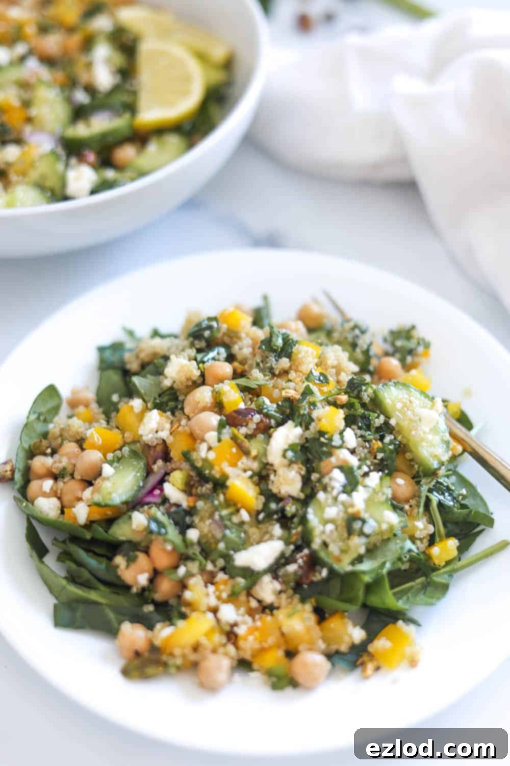 Bowl of the viral Jennifer Aniston Salad with chickpeas, quinoa, fresh veggies, and a lemon vinaigrette, ready to be enjoyed as a healthy meal.