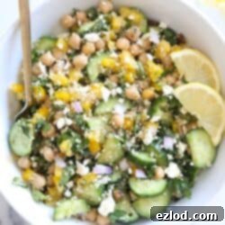 Bowl of the viral Jennifer Aniston Salad with chickpeas, quinoa, fresh veggies, and a lemon vinaigrette.