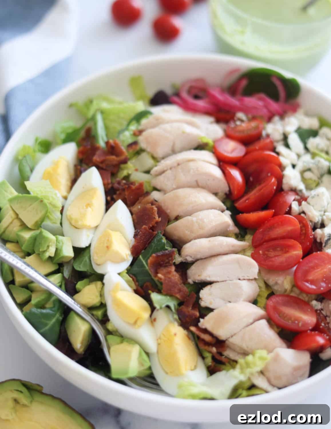 A close-up shot of the vibrant ingredients in a bowl of Copycat Panera Green Goddess Cobb Salad, highlighting the fresh textures.