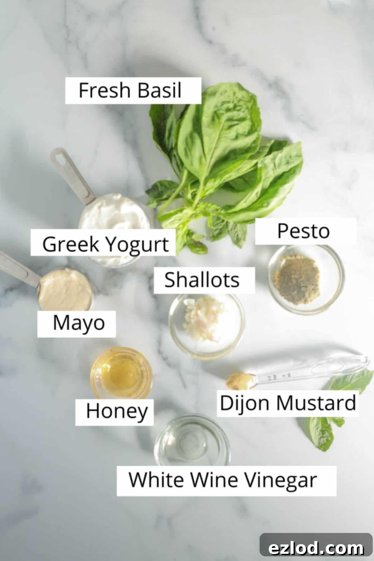Fresh ingredients for the homemade Green Goddess Dressing from Panera, including basil, Greek yogurt, and mayonnaise.