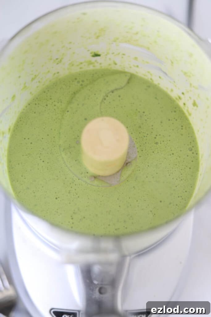 Smooth and creamy Green Goddess Dressing blended in a food processor, ready for the Panera Cobb Salad.