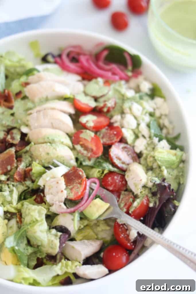 A finished Cobb Salad generously drizzled with homemade Copycat Panera Green Goddess Dressing.