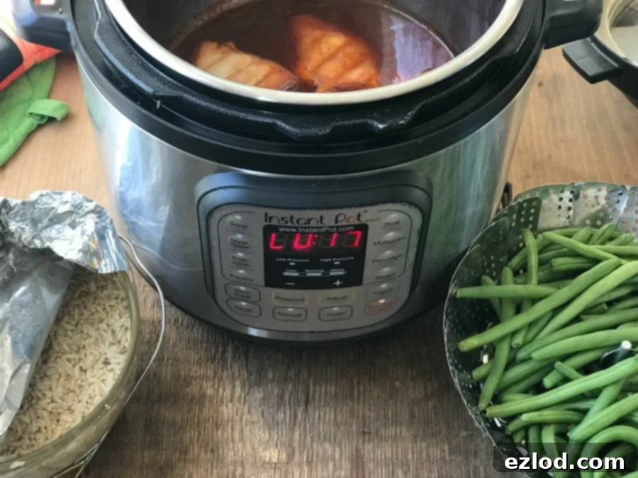 Instant Pot with Asian Flavored Chicken Rice and Green Beans being cooked