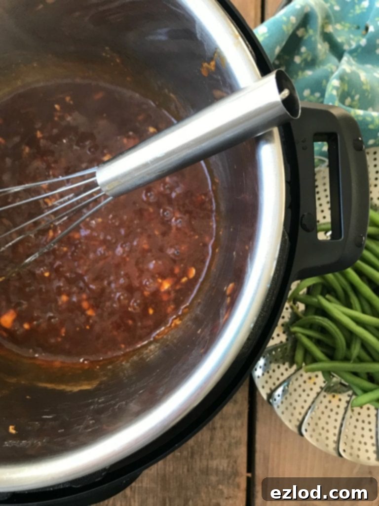 Instant Pot Asian Chicken Sauce with Green beans on the side, ready to be thickened