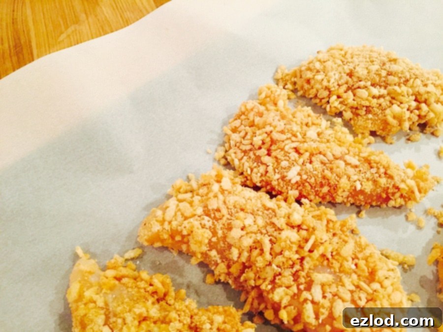 Plated 21 Day Fix Krispie Baked Chicken tenderloin with a side dish
