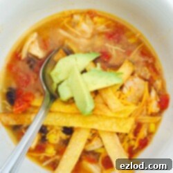 A bowl of flavorful Instant Pot Chicken Tortilla Soup with all the delicious toppings.