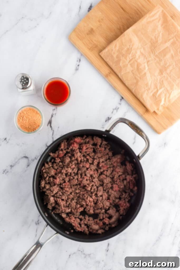 Our Favorite Simple and Healthy Taco Salad Recipe 6 Ground beef taco meat simmering in a skillet.
