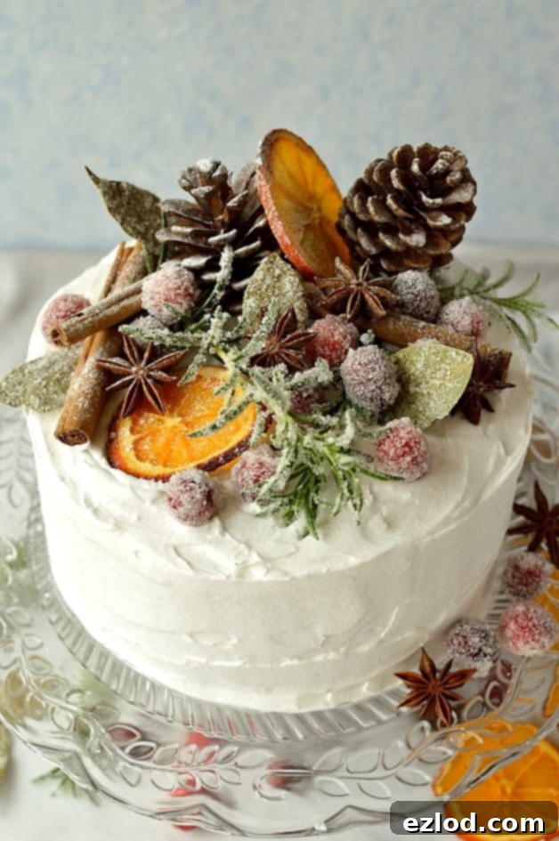 Gingery Christmas fruitcake topped with marzipan, royal icing, sugared cranberries, rosemary and bay leaves, dried orange slices, pine cones and whole spices - Domestic Gothess