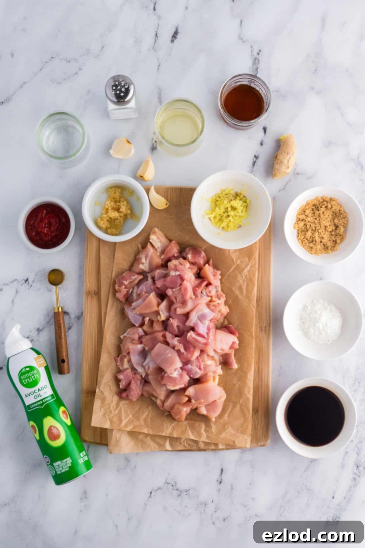All the fresh ingredients laid out for making delicious homemade bourbon chicken, including chicken, spices, and sauce components.