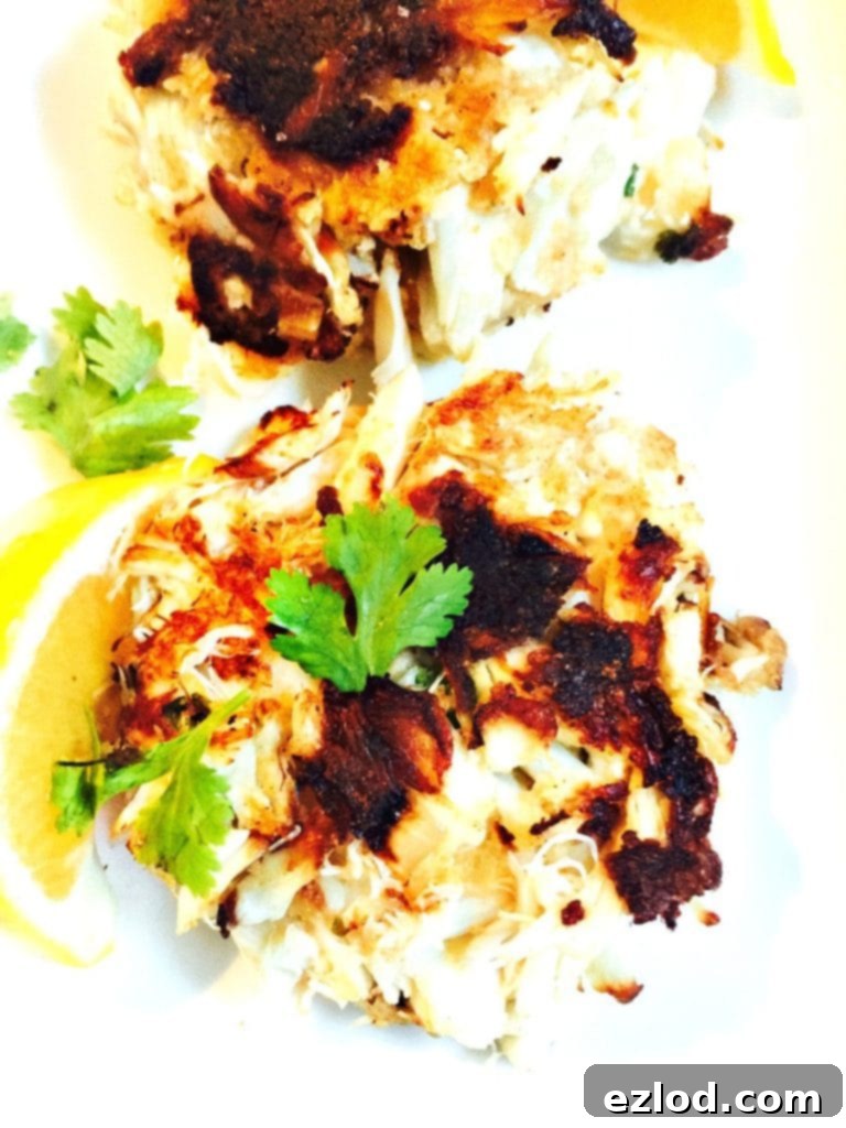Delicious freshly cooked gluten-free jumbo lump crab cakes on a plate.