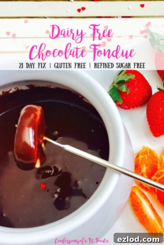 Close up photo of chocolate fondue recipe with a mandarin orange dipped into the white bowl. Extra fruit is off to the side. There is a text overlay- Dairy Free Chocolate Fondue | 21 Day Fix | Gluten Free | Refined Sugar Free | Confessions of a Fit Foodie