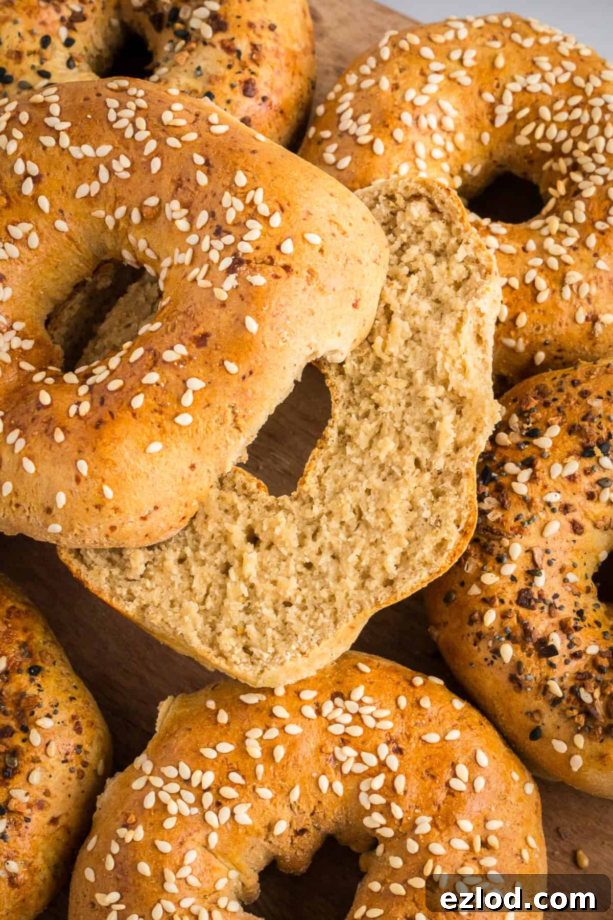 a pile of sliced gluten-free bagels shot from overhead with sesame seeds and everything bagel seasoning on top