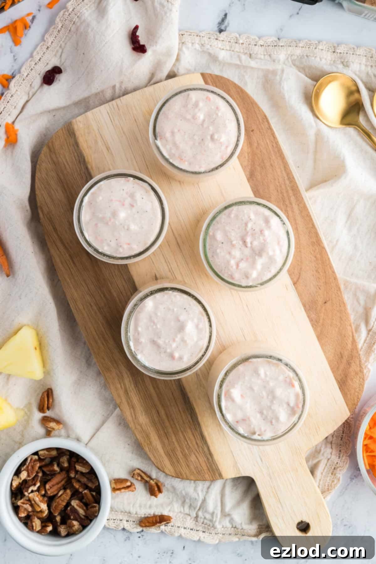 Carrot cake cheesecake divided into multiple small mason jars.