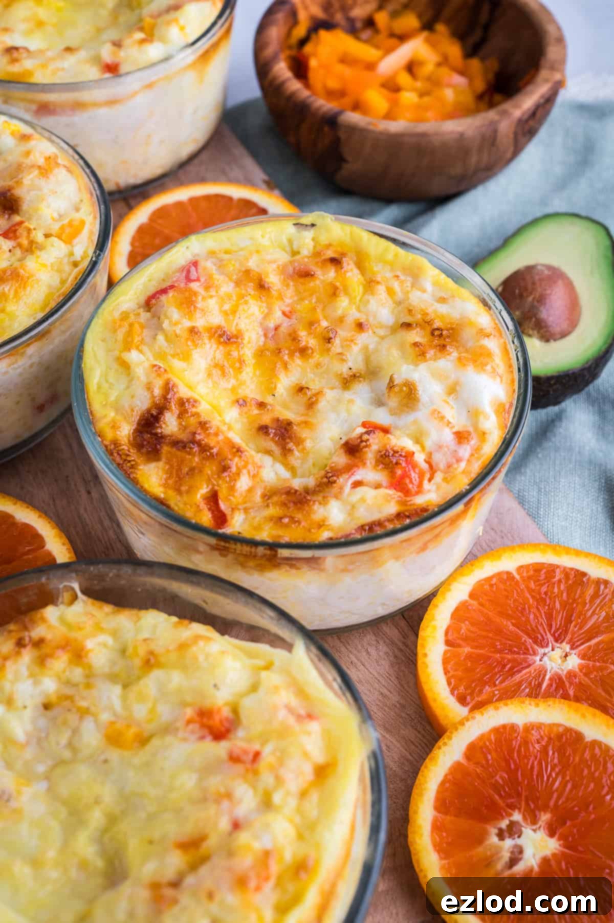 Baked meal prep breakfast bowl with avocdado and oranges in the background.