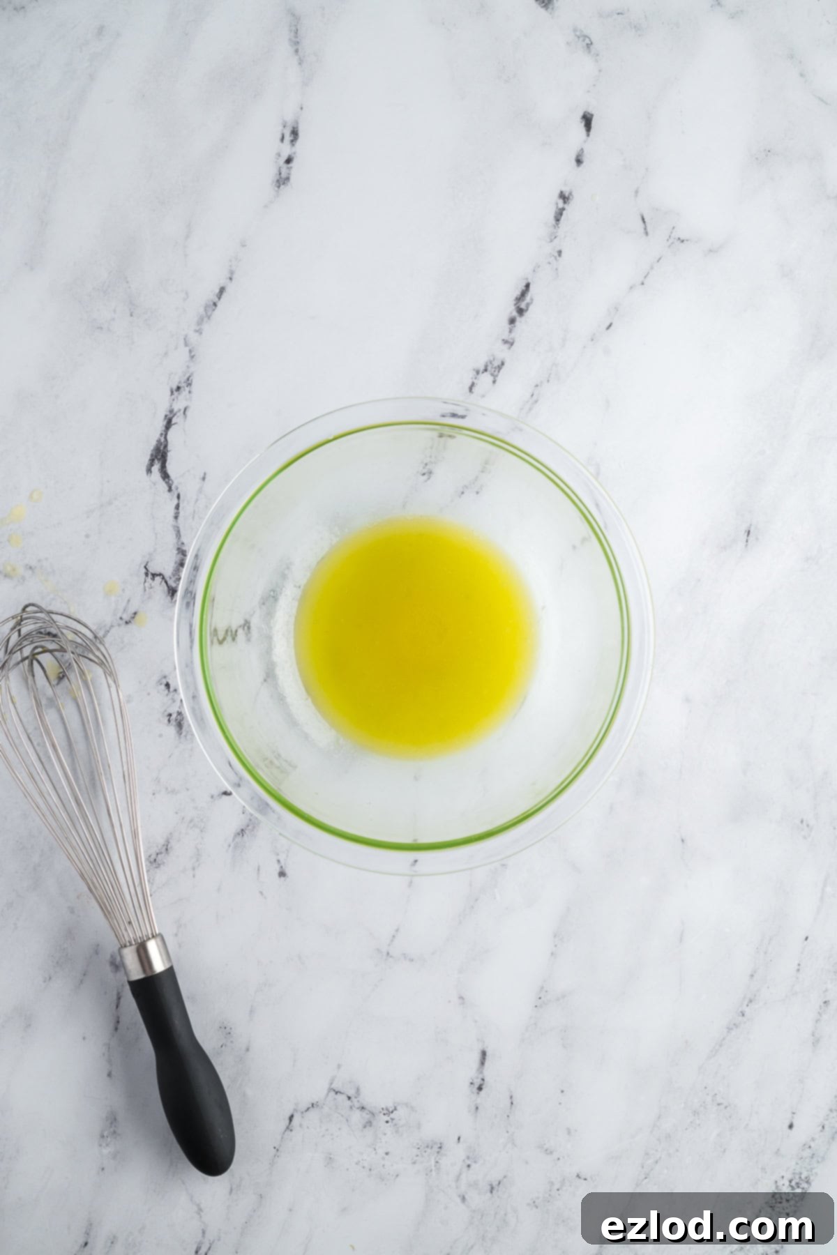 Lemon juice, olive oil, and honey whisked together in a small bowl to make a vinaigrette.