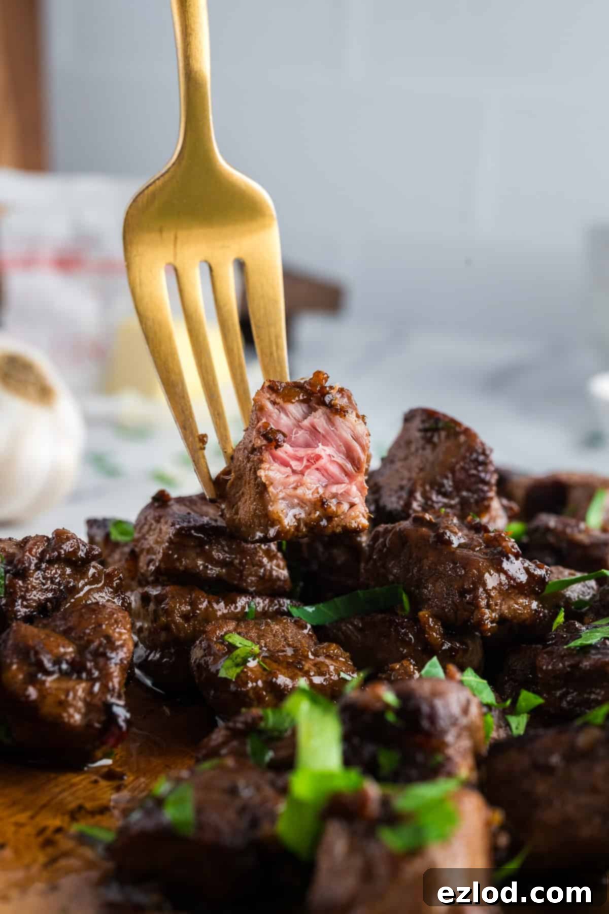 Close up of steak bites on a gold fork.