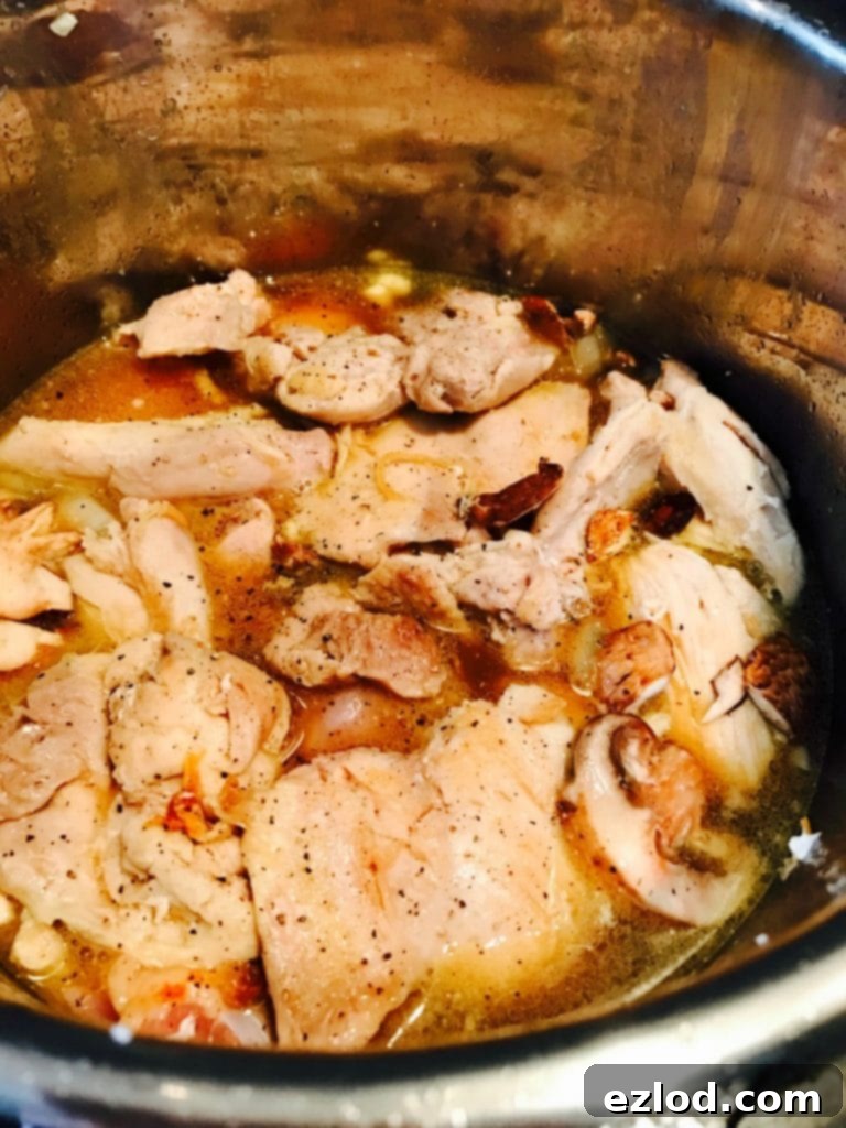 Serving of healthy Instant Pot Chicken Marsala with sauce and mushrooms.