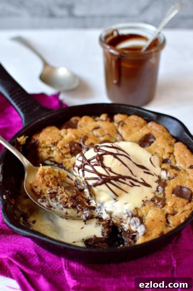 Close-up of a gooey Nutella stuffed chocolate chip pizookie, with perfectly crispy edges, ready for sharing.