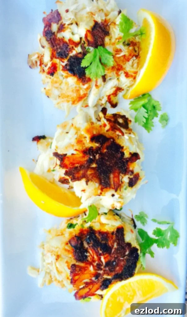 Delicious crab cakes, perfectly golden brown, served with a fresh salad, emphasizing healthy gourmet options.