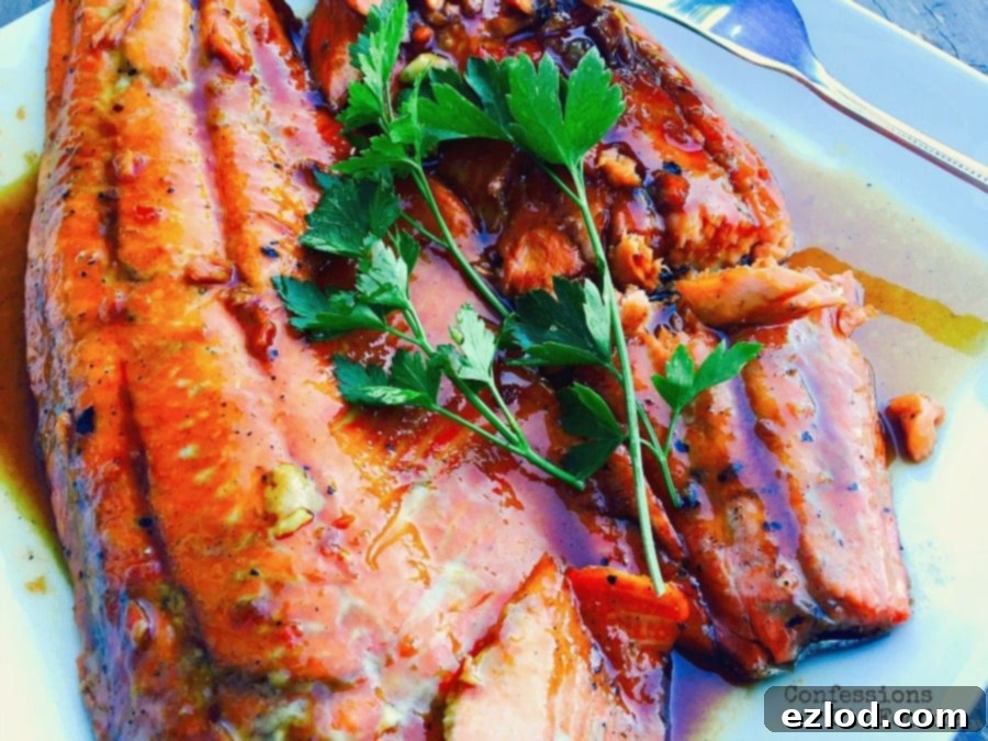 A perfectly cooked salmon fillet, golden and flaky, served with fresh herbs, ready for a healthy meal.