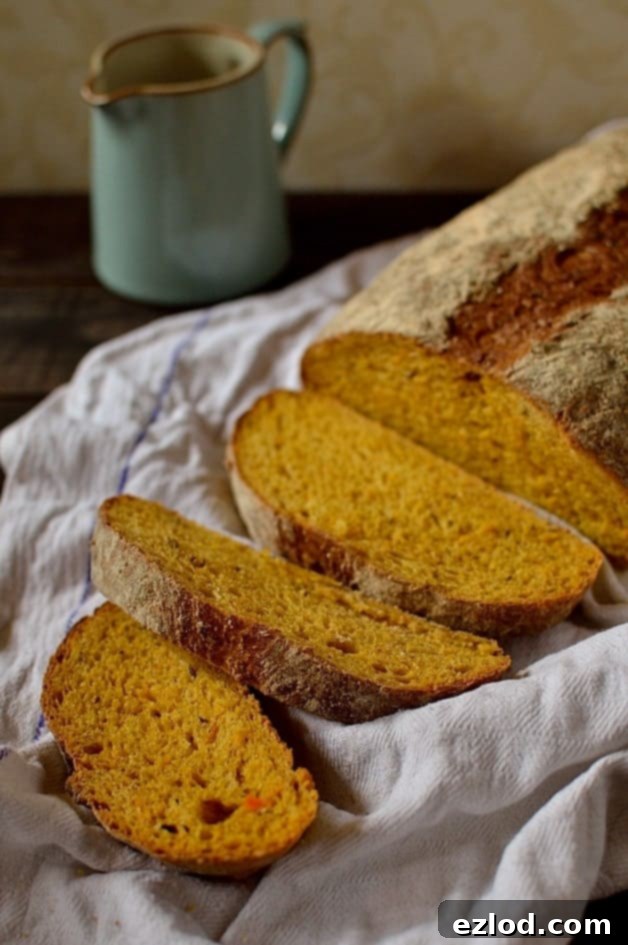 A freshly baked, golden brown loaf of carrot and caraway seed bread cooling on a wire rack, ready to be enjoyed.