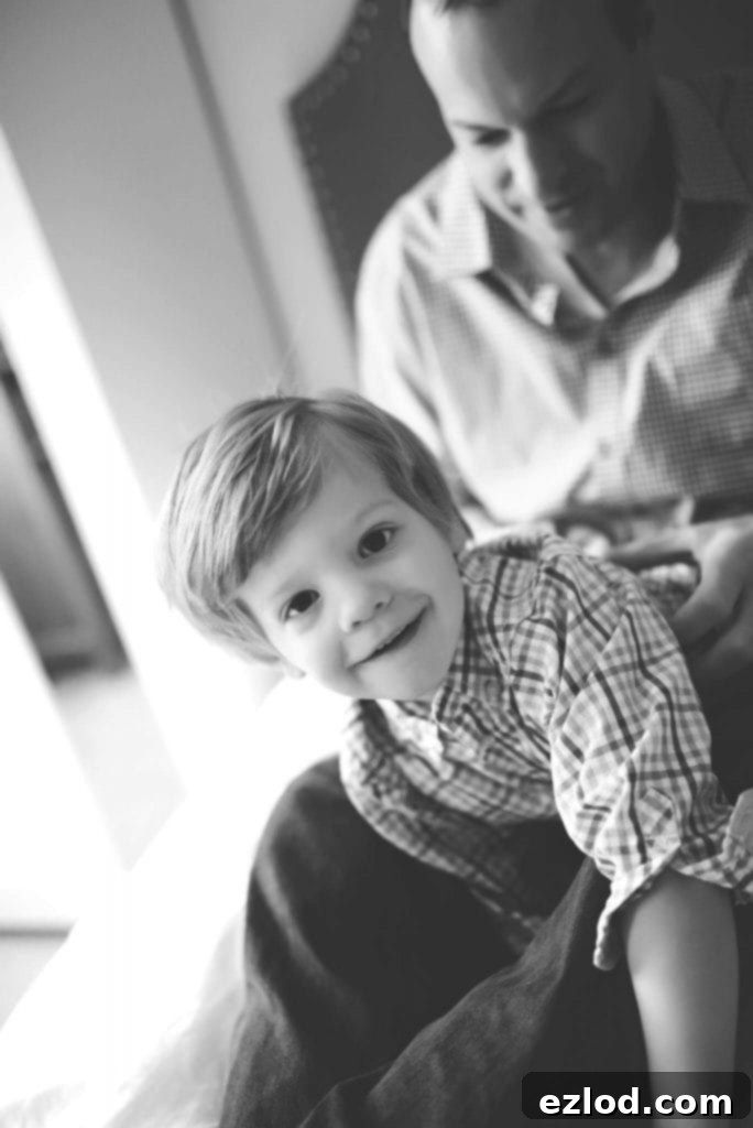 Max sitting on the floor, focused on an activity, during his early intervention therapies.
