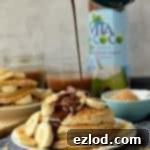 Decadent Toasted Coconut Pancakes with Rich Fudge Drizzle 5 Toasted coconut pancakes with chocolate fudge sauce and banana, a decadent breakfast or brunch.