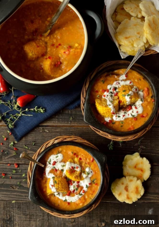 Delicious cheese-filled arepas served alongside a bowl of rich spiced yellow split pea and sweetcorn soup