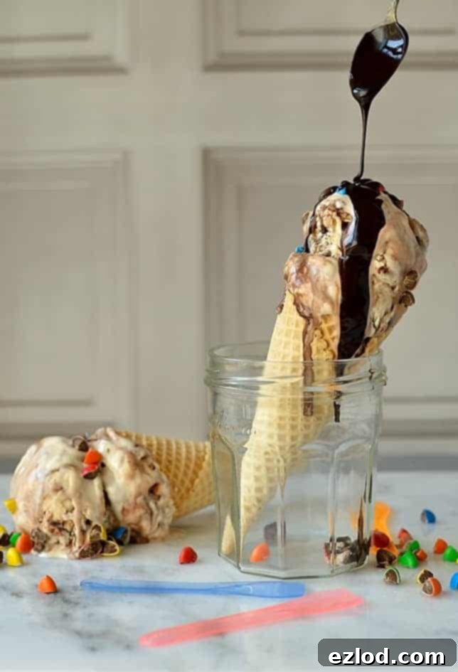 Easy, no-churn M&M's cookie dough ice cream with chocolate fudge swirl, perfect for any celebration or a sweet treat