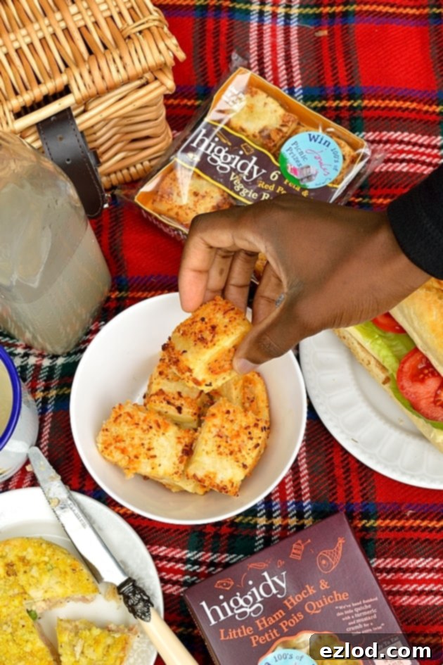 A picnic spread with Higgidy food, sandwiches, cheese, and homemade cakes.