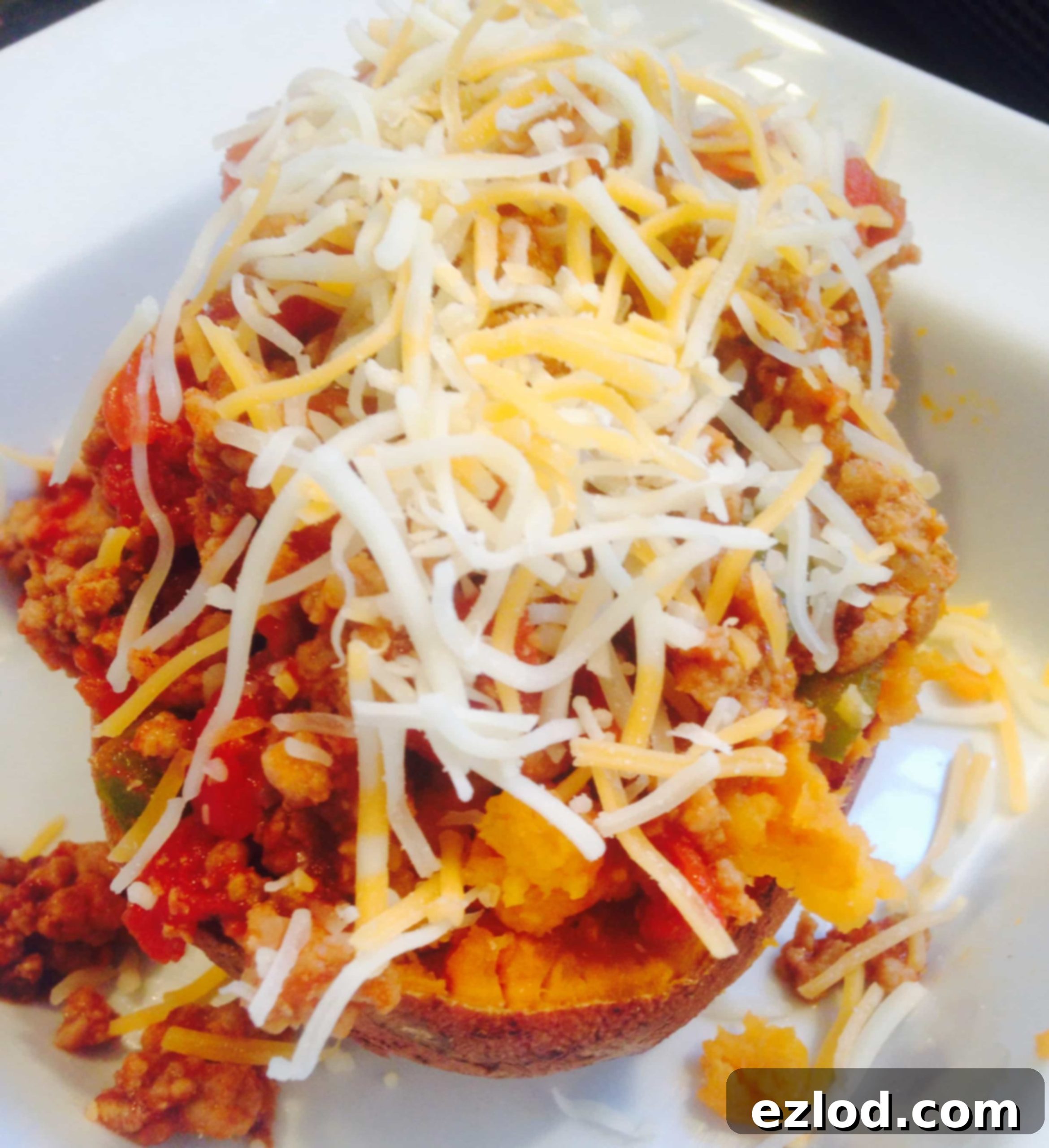 Delicious Sloppy Joe mixture simmering in a skillet, with diced peppers and onions, forming a flavorful sauce