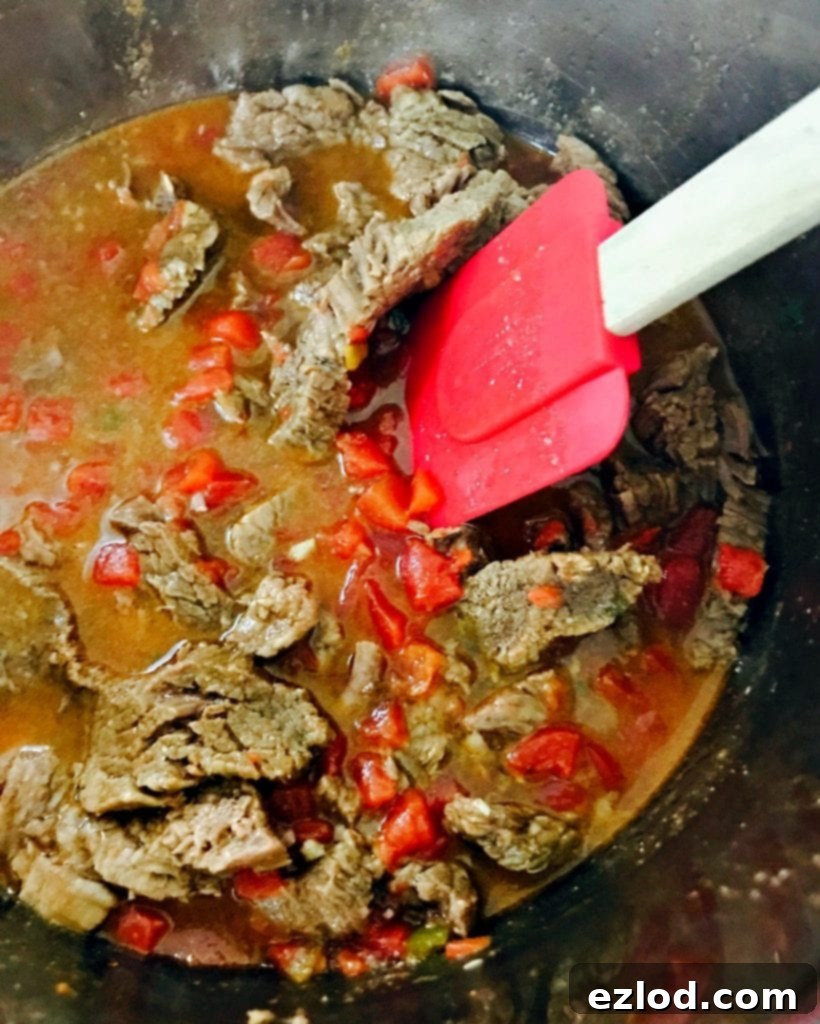 Tender Instant Pot Flank Steak Tacos 4 A vibrant close-up of two Instant Pot Flank Steak Tacos, showcasing the tender steak, refreshing cilantro lime slaw, and fresh cilantro, embodying a healthy and delicious meal.