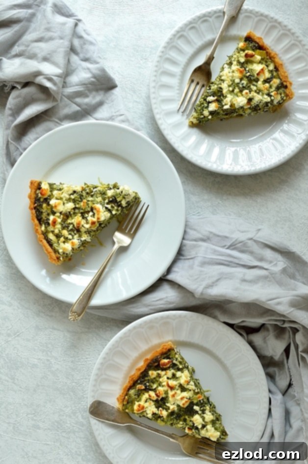 A beautifully baked Spinach, Ricotta, and Feta Quiche with a golden parmesan shortcrust, showcasing a perfect slice ready to be served. Ideal for brunch or dinner.
