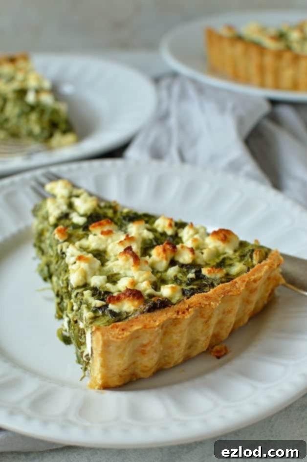 A freshly baked Spinach, Ricotta, and Feta Quiche, showcasing its golden crust and vibrant filling, ready for a delicious meal. Perfect for family or guests.