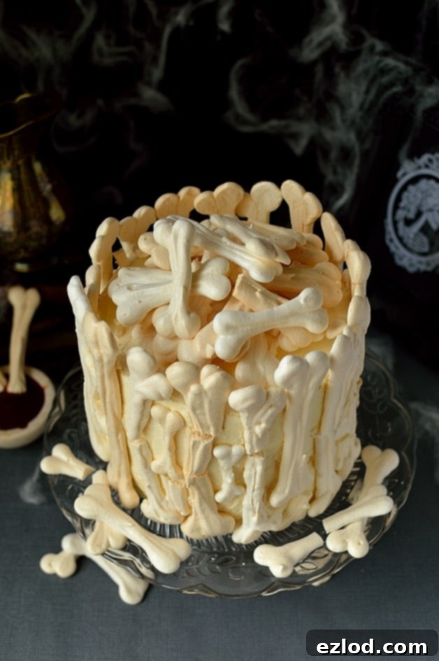Full view of the Meringue Bone Garden Halloween Cake, showcasing its impressive height and intricate bone details, ready for a spooky celebration